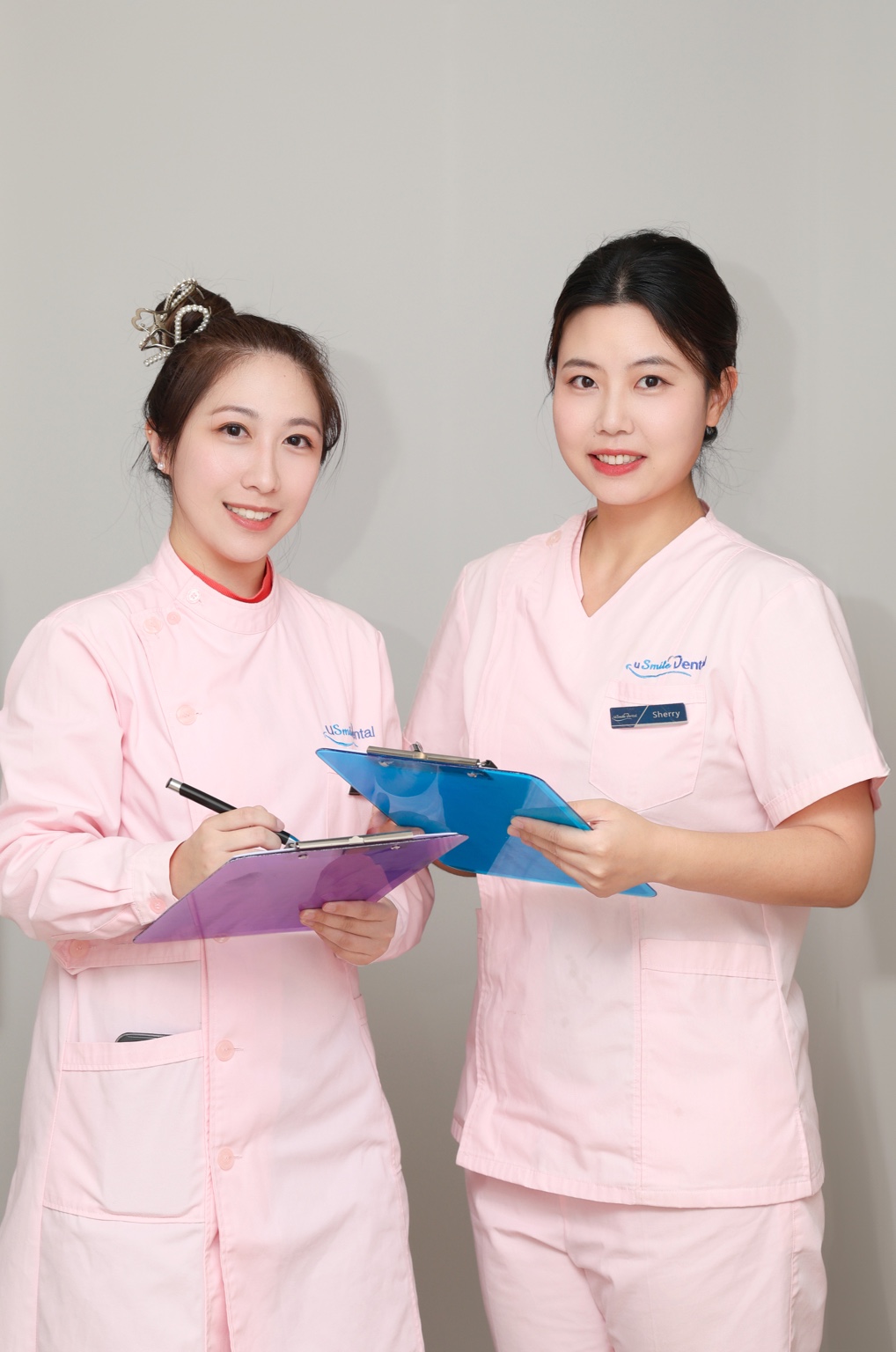 Two uSmile team members welcoming patients